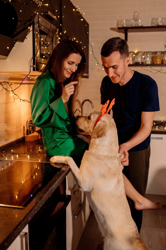 Celebrating Valentine's Day With Your Pet - couple and dog in kitchen