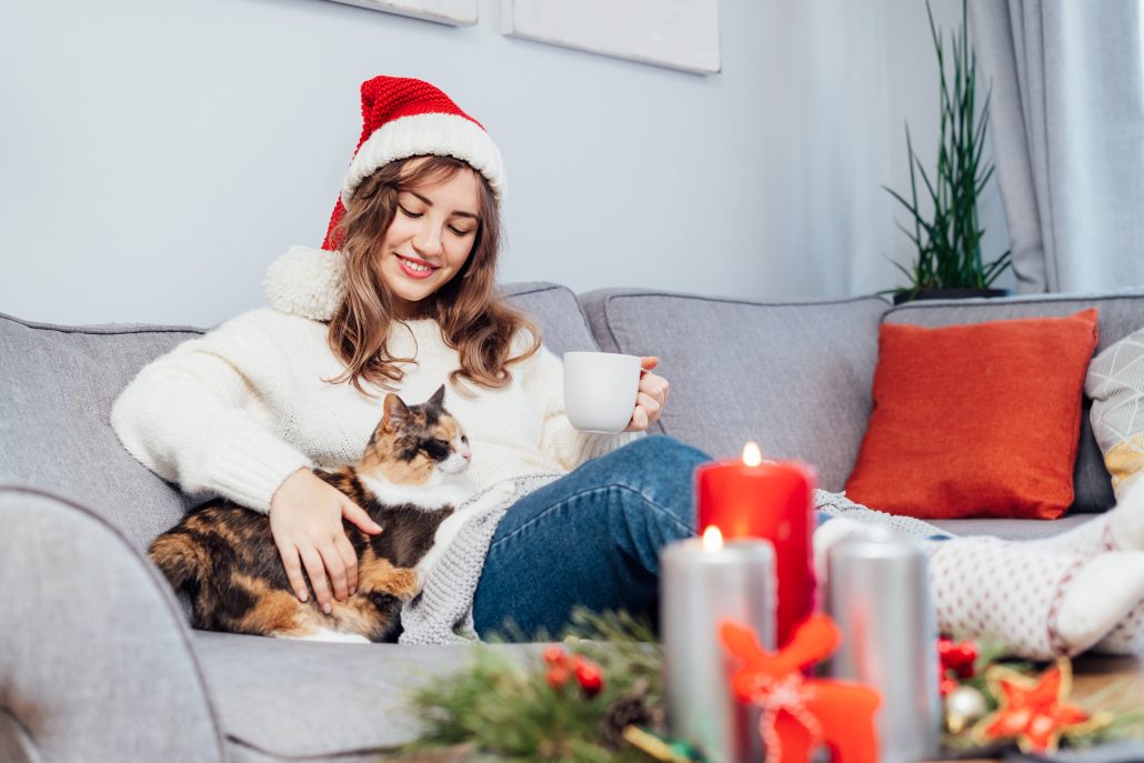 Woman creating a calm space for their pet during christmas