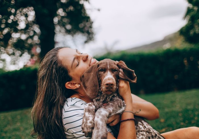 Travelling With Your Pets - owner hugging pet