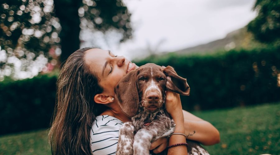 Travelling With Your Pets - owner hugging pet